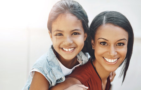 Portrait, woman and child as family with piggyback, love or support in bonding, together and relationship. Mom, kid and happy in outdoor on weekend, break or holiday for development, growth or careの写真素材