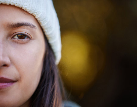 Woman, half face and outdoor with beanie for winter style, cotton material or fashion item. Closeup, nature and female person for cold season, luxury fabric or hat with mockup in Switzerlandの写真素材