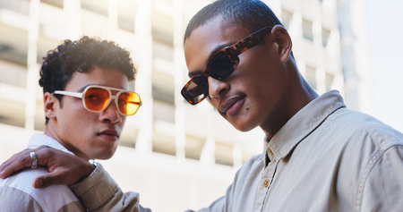 Men, friends and portrait in city with fashion for university travel in urban town for education or scholarship with trendy style. People, sunglasses and gen z students with confidence in Amsterdam.の写真素材