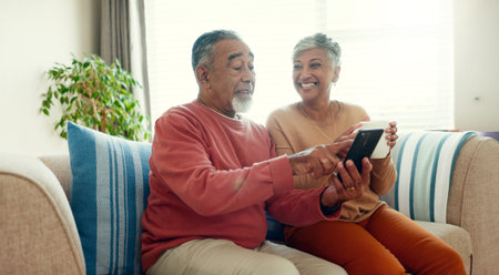 Mature couple, home and happy with smartphone on sofa for learning social media, networking and...