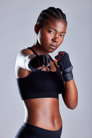 Studio, serious and black woman with gloves for boxing, portrait and ready for fight and...