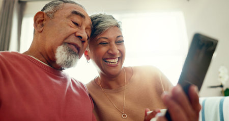 Video call, smile and senior couple on sofa with mobile for communication, networking or chat....