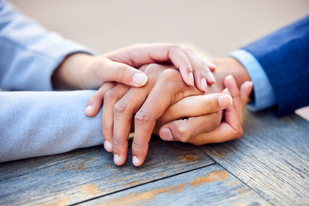 Hands, holding and business people with comforting outside for support with colleague or motivation. Together, work and consoling for job loss or grief with help for care with respect for coworker.の写真素材