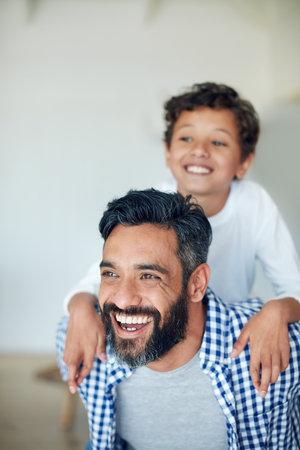 Family, piggy back and father with child in home for bonding, love and relationship in living room. Parents, happy and dad with young boy in house for playing, childhood and relaxing on weekendの写真素材