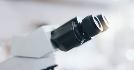Closeup, science and microscope in lab for research, experiment or innovation. Microbiology, tools...