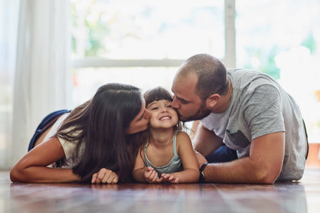 Family, girl and kiss in home on floor with smile for fun, bonding and support for child...