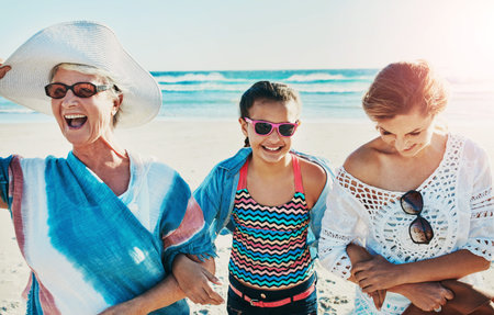 Grandma, daughter and girl in beach with smile for fun on summer holiday or vacation and break....
