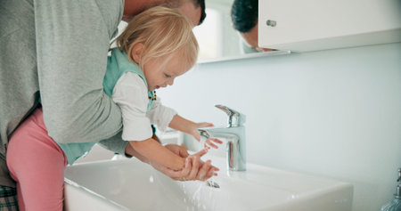 Child, dad and washing hands in bathroom for growth, development and hygiene in home. Toddler, girl...