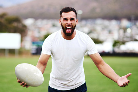Rugby players dont talk, they roar. Portrait of an enthusiastic young man playing a game of rugby.の写真素材