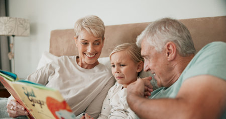 Grandparents, girl and reading a fairytale story, literature and scary book for bonding at...