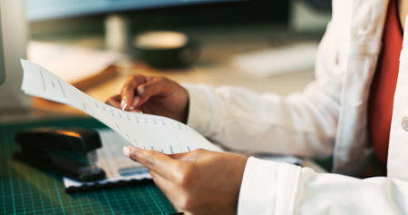 Hands, receipt and paperwork for accounting in home office for reading, review or taxes with remote work. Person, document and financial admin for check, audit or balance books at apartment in Mumbaiの写真素材