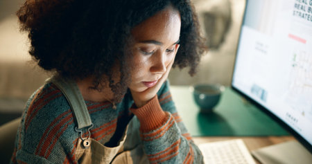 Education, woman and thinking at night by computer, research or reading at table. Female student,...