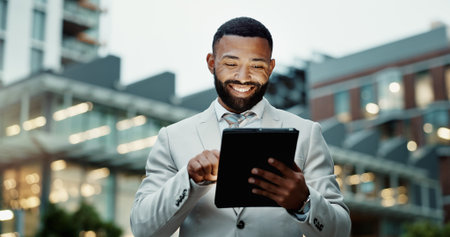 Man, outside and browsing on business tablet, email and news update in city for social networking online. Technology, website search and corporate career, internet communication and digital appの写真素材