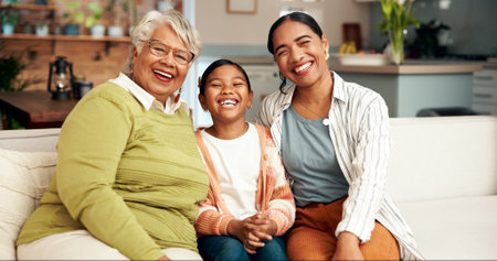 Family generations, smile and portrait on sofa for bonding, support and relationship for childhood memory. Happy, grandparent and woman with child for care, fun and love together at house loungeの写真素材