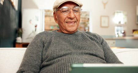 Senior man, tablet and sofa for social media and scrolling, technology and home for relax in living...