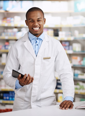 Pharmacy, smile and portrait of black man with tablet, customer service and medical help. Prescription drugs, medicine and pharmacist with digital app for healthcare, online advice and confidenceの写真素材