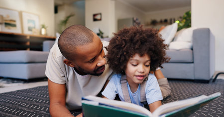 Reading, dad and child with book on floor for education, learning or language development in living room. Love, African man and girl lying on rug for literacy, storytelling or knowledge in homeの写真素材