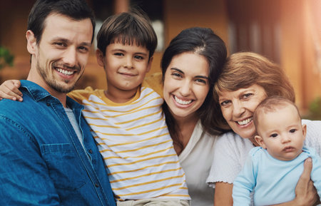 Big family, portrait and outside their home with grandmother, parents and baby together. Love, smile and father relax with mother and happy child in house garden with support and care in backyardの写真素材