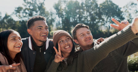 Selfie, smile and friends in nature outdoor for camping, adventure weekend and trail hiking for bonding. People, photography and peace sign together in wilderness for memory, social media and post.の写真素材