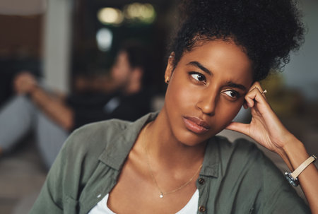 Black woman, stress and divorce fight in home with ignoring partner, frustrated and problem for toxic marriage. African lady, angry and conflict for infidelity, cheating man or gambling confessionの写真素材
