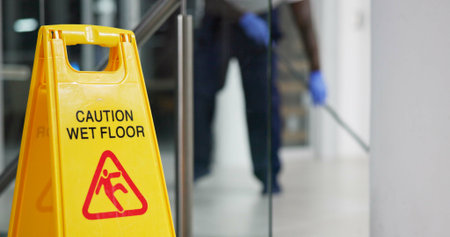Caution, sign and cleaning for floor, janitor and hygiene service and dark at night in office. Mop,...