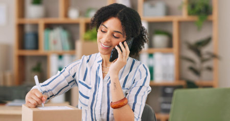 Phone call, boxes and writing with smile, woman and small business of ecommerce, entrepreneur and listening. Office, startup and person with communication, storage and digital for shop and webの写真素材