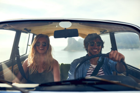 Love, road trip and smile with couple in car together for holiday, travel or vacation adventure....