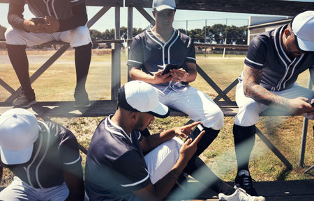 Baseball player, men and team with phone on field, break and relax at stadium with texting on social...