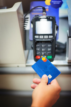 Hand, pos machine and credit card for cashless purchase, banking and account funds for access, money and debit. Closeup, person and transaction with mockup space, payment or sale in digital scannerの写真素材