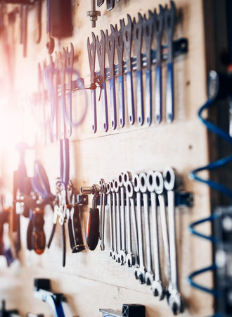 Board, carpentry and tools in workshop, layout and engineering with equipment, organised and repair. Empty, craft and maintenance with manufacturing, industry and process with storage and operationsの写真素材