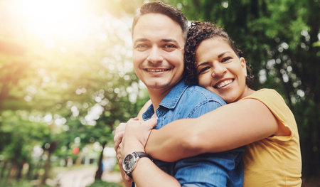 Couple, hug and park for love and support, unity or trust for married people in nature for exercise. smile, embrace or romance for man and female person in garden, portrait or outdoors with affectionの写真素材