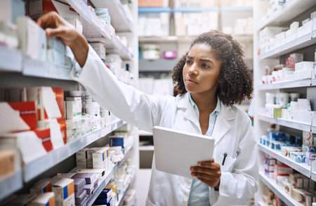 Pharmacy, healthcare and black woman with medicine, inventory and tablet for checklist in store for pills. Shop, person and reading of label, seriously and confused of info on product, fake or dangerの写真素材