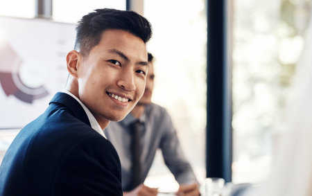 Workplace, portrait and businessman in meeting, corporate and training workshop for project feedback. Office, coworker or male consultant with smile for networking, professional growth and confidentの写真素材