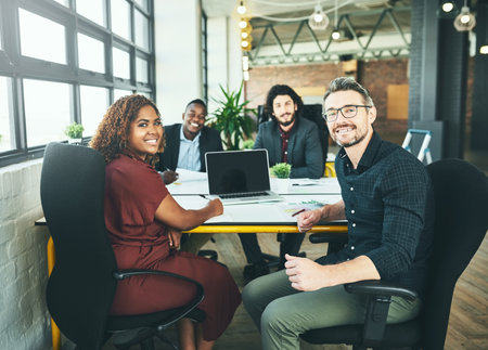 Office, smile and portrait of colleagues, laptop and review of paperwork in project and men. Screen, web designer and diversity of teamwork, creative and people in workplace, online and womanの写真素材