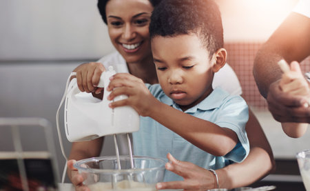 Mother, child and baking with whisk machine for bonding, family time or help in kitchen at home....
