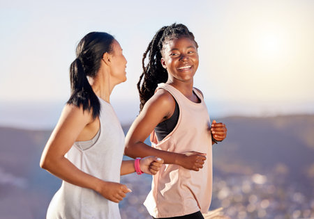 Happy, fitness and people with running in nature for cardio exercise, energy and healthy body. Friends, mountain and athlete with workout for endurance, sports and training for marathon togetherの写真素材
