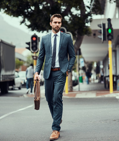 Business man, briefcase and crosswalk on street in city by traffic light, safety and sign for direction to work. Person, suit and leather bag in metro on commute, walking and trip to job in Seattleの写真素材