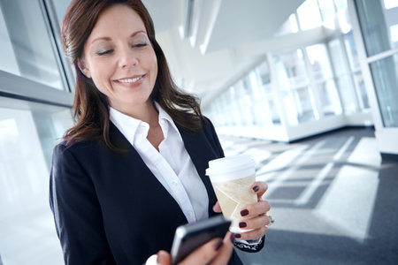 Businesswoman, smile and lawyer office or smartphone, coffee and browse internet or court proceedings. Legal, representative and attorney for communication, law firm and online for justice adviceの写真素材