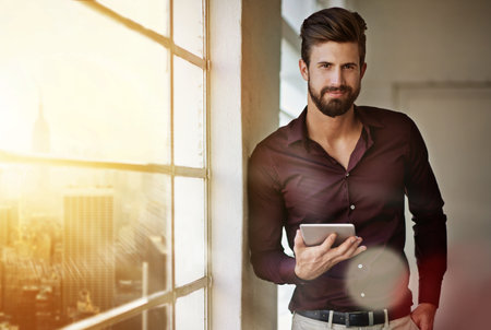 Creative, man and portrait with tablet in workplace for digital sketching, professional and online for networking. Branding or graphic designer, happy and internet for visual creation and logo designの写真素材