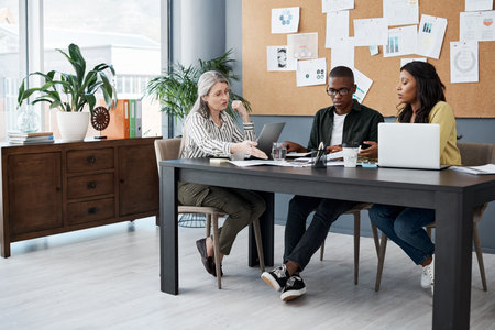 Office, desk and business people with laptop in meeting for sales review, planning and...