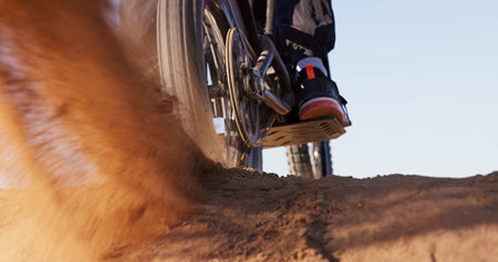Sand, dust and motorbike wheel for sports with power speed of training, performance technique and...