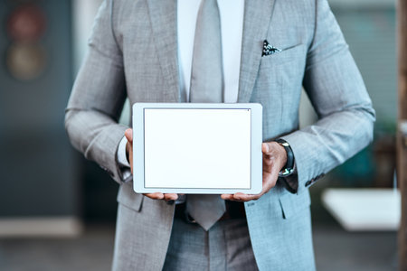 Businessman, hands and presentation with tablet screen for advertising or marketing at office. Closeup of man, employee or technology display for app, web or software on mockup space at workplaceの写真素材
