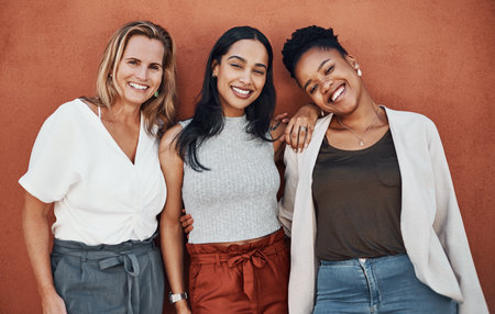 Wall background, happy and portrait of business women in city for teamwork, collaboration and about us. Creative agency, startup and people with confidence, company pride and working togetherの写真素材