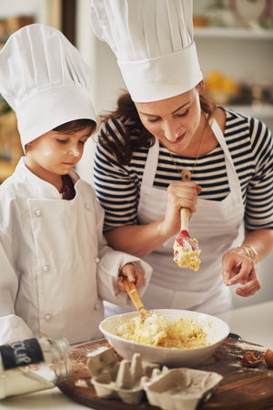 Mom, learning or boy mixing to bake in kitchen for growth development, education or skills in family...