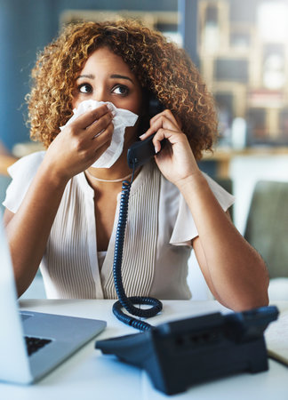 Phone call, blowing nose or sick woman with tissue, flu or allergy with cold, illness or infection. Laptop, secretary or African receptionist sneezing with toilet paper, virus or hayfever diseaseの写真素材