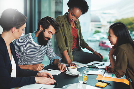 Business people, meeting and employee training with paperwork for learning and brainstorming in office. Trainee group, teamwork and training seminar with documents for intern feedback and supportの写真素材