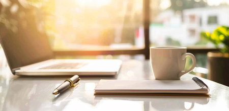 Home office, notebook and laptop on table with coffee, sunrise glow or interior design. Remote workの素材