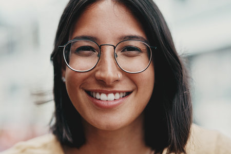 Happy, woman and portrait with glasses outdoor for eyesight or clear vision, optometry wellness and prescription lens. Female student, spectacles and smile for eye care and ocular surface disease.の写真素材