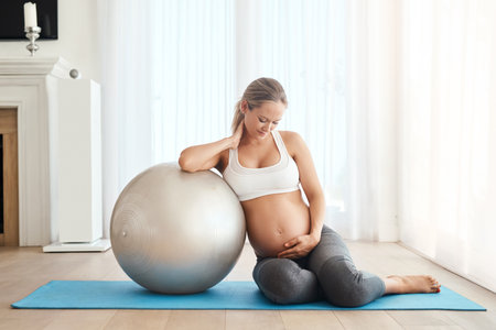 Relax, smile and pregnant woman with exercise ball in home for healthy weight gain, circulation and balance. Girl, joy and yoga in house for pelvic floor strength, flexibility and back relief.の写真素材