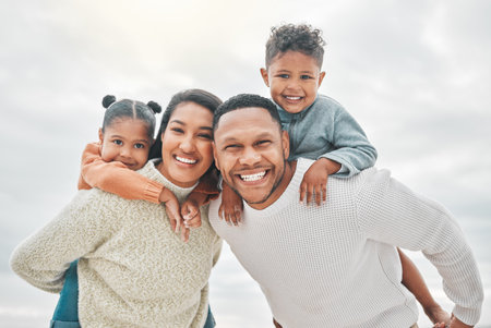 Beach portrait, parents and piggyback for children with family connection, holiday and outdoor bonding. Mom, dad and kids on back by ocean for vacation travel with love, security and care in Mexicoの写真素材
